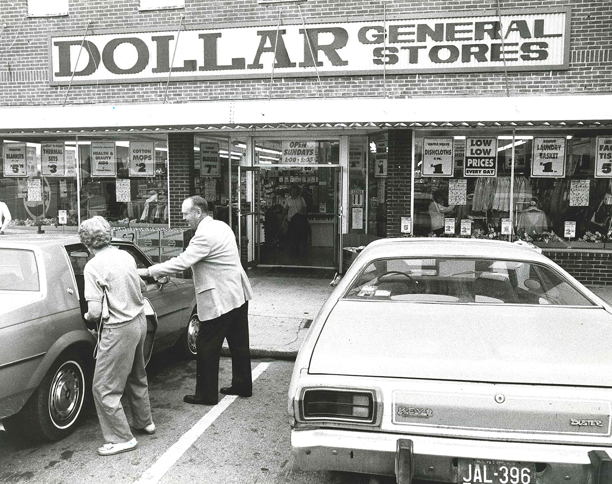 Cal Turner, Sr. helping a customer into their car.