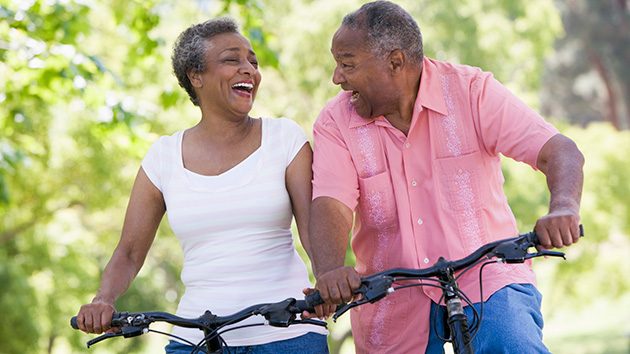 Happy couple riding a bicycle