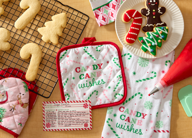 Holiday baking essentials featuring Candy Cane Wishes kitchen linens, sugar cookies and decorated treats