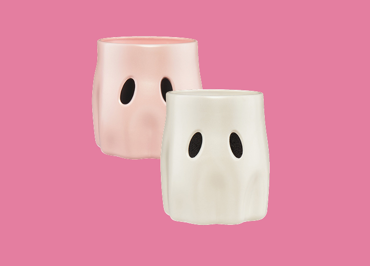 Ghost-shaped buckets for Halloween candy on pink background