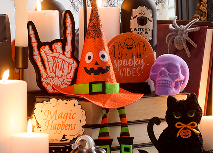 Happy Halloween decor with ghost figure, black cat, skull accents and seasonal decorations