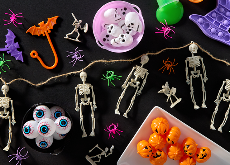 Happy Halloween decor and party supplies with Trick or Treat candy bucket and seasonal treats
