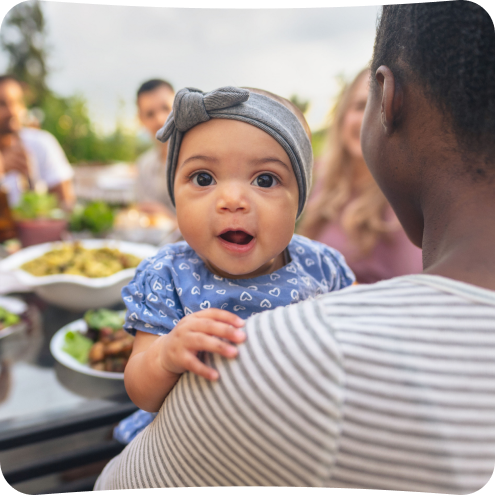 Dad holding toddler daughter