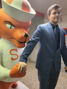 person in suit with a statue