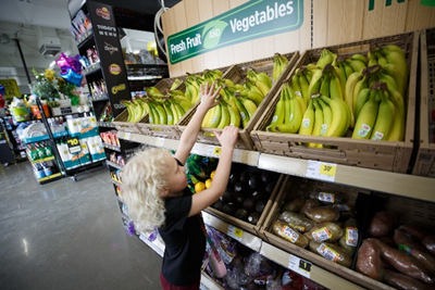 Child reaching for bananas
