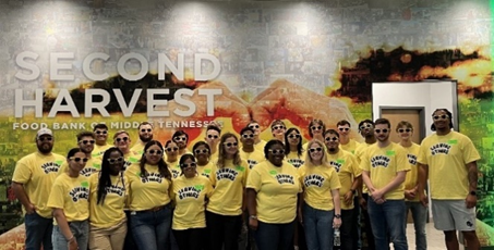 people posing in front of a camera with yellow t-shirts